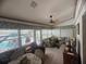 Cozy sunroom with comfortable furniture, ceiling fan and views of the pool at 620 Camellia Ave, Ellenton, FL 34222