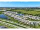 An aerial shot featuring a vibrant residential area, serene lakes, and lush green landscapes, capturing the essence of community living at 6219 Golden Nettle Dr, Apollo Beach, FL 33572