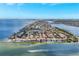 Aerial view of a coastal community on a peninsula, surrounded by ocean, with boat and marina at 6219 Golden Nettle Dr, Apollo Beach, FL 33572