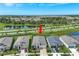Aerial view of a modern two-story home with a well-manicured lawn and landscaping in a suburban neighborhood at 6219 Golden Nettle Dr, Apollo Beach, FL 33572