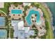 Aerial view of a resort-style pool area featuring a pool with slides, a lap pool, lounge chairs and a clubhouse at 6219 Golden Nettle Dr, Apollo Beach, FL 33572