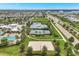 Aerial view of community amenities with tennis courts, volleyball court, lush green spaces, a pool and clubhouse for community enjoyment at 6219 Golden Nettle Dr, Apollo Beach, FL 33572