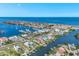 Aerial view showcasing a coastal community with ocean views, a harbor full of boats, and stunning residential architecture at 6219 Golden Nettle Dr, Apollo Beach, FL 33572