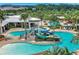 Aerial view of a community pool featuring a water slide, zero entry, ample seating and resort-style amenities at 6219 Golden Nettle Dr, Apollo Beach, FL 33572