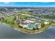 Aerial view of a community pool area, with waterslides, lounge chairs and sun umbrellas, set amongst palm trees and landscaping at 6219 Golden Nettle Dr, Apollo Beach, FL 33572
