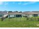 Exterior view of the home showcasing the screened lanai and a large, fenced backyard at 6219 Golden Nettle Dr, Apollo Beach, FL 33572