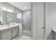 Modern bathroom featuring a glass-enclosed shower, gray tile, and vanity with countertop at 6219 Golden Nettle Dr, Apollo Beach, FL 33572