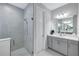 Beautiful bathroom featuring glass shower enclosure, vanity with countertop, and gray tiled walls at 6219 Golden Nettle Dr, Apollo Beach, FL 33572