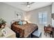 Cozy bedroom featuring carpet floors, ceiling fan, shuttered window, and traditional decor at 6219 Golden Nettle Dr, Apollo Beach, FL 33572
