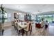 Open dining room with a large table, chairs, and a view of the screened lanai at 6219 Golden Nettle Dr, Apollo Beach, FL 33572