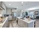 Gourmet kitchen features a large center island, stainless steel appliances, quartz countertops, and shaker cabinets at 6219 Golden Nettle Dr, Apollo Beach, FL 33572