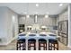 Gorgeous kitchen with a spacious center island, bar seating, pendant lighting, stainless appliances, and shaker cabinets at 6219 Golden Nettle Dr, Apollo Beach, FL 33572