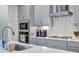 Gourmet kitchen boasts quartz countertops, stainless appliances, tile backsplash, and plenty of cabinet space at 6219 Golden Nettle Dr, Apollo Beach, FL 33572