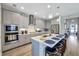 This spacious kitchen features a center island, bar seating, pendant lighting, stainless appliances, and shaker cabinets at 6219 Golden Nettle Dr, Apollo Beach, FL 33572