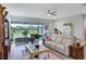 Comfortable living room featuring a large sofa, wood floors, and view of the landscaped backyard at 6219 Golden Nettle Dr, Apollo Beach, FL 33572