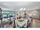 Open-concept living room and kitchen with stainless appliances, dining area, and sliding doors leading to the lanai at 6219 Golden Nettle Dr, Apollo Beach, FL 33572