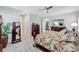 Bright main bedroom showing carpet floors, ceiling fan, and ensuite bathroom at 6219 Golden Nettle Dr, Apollo Beach, FL 33572