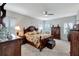 Spacious main bedroom featuring carpet floors, ceiling fan, and plantation shutters at 6219 Golden Nettle Dr, Apollo Beach, FL 33572