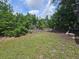 Lush backyard featuring a well-maintained lawn with plenty of surrounding trees and shrubs at 6305 Bikini Rd, Sarasota, FL 34241