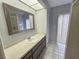Bathroom featuring a large mirror, vanity, and tiled floors at 6305 Bikini Rd, Sarasota, FL 34241