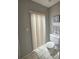Cozy bathroom with a toilet and a window with vertical blinds at 6305 Bikini Rd, Sarasota, FL 34241
