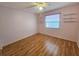 Cozy bedroom features wood floors, a large window, and built-in shelving at 6305 Bikini Rd, Sarasota, FL 34241