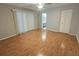 Light-filled bedroom featuring wood floors, ceiling fan, and a view to ensuite bathroom at 6305 Bikini Rd, Sarasota, FL 34241