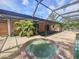 Outdoor spa situated under a screened lanai, perfect for relaxation and entertaining at 6305 Bikini Rd, Sarasota, FL 34241