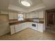 Bright kitchen features white cabinets, tile floors and neutral countertops at 6305 Bikini Rd, Sarasota, FL 34241