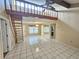 Living room with tile floors, stairway, and a view of the loft space above at 6305 Bikini Rd, Sarasota, FL 34241
