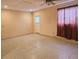 Bright living room featuring neutral walls, tile floors, and a ceiling fan with light at 6305 Bikini Rd, Sarasota, FL 34241