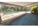 Enclosed in a screened lanai, this backyard pool area includes a spa and a table with seating at 6305 Bikini Rd, Sarasota, FL 34241