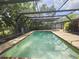 This spacious pool area offers a serene retreat with its screened lanai and verdant surroundings at 6305 Bikini Rd, Sarasota, FL 34241
