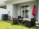 Backyard with patio furniture and umbrella. Exterior door at 6358 Fairmont Ln, Palmetto, FL 34221