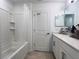 Bright bathroom features a shower-tub combo with white tile and a vanity with updated fixtures and plenty of storage at 6358 Fairmont Ln, Palmetto, FL 34221