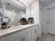 Well-lit bathroom featuring an extended vanity and mirror, complemented by modern fixtures and neutral tile flooring at 6358 Fairmont Ln, Palmetto, FL 34221