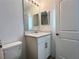 Bathroom featuring a vanity, mirror, and toilet, creating a comfortable and practical space at 6358 Fairmont Ln, Palmetto, FL 34221