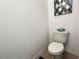 Bathroom with standard toilet and geometric artwork at 6358 Fairmont Ln, Palmetto, FL 34221