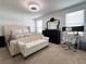Bright bedroom featuring a tufted bed, bench, dark dresser, and a dedicated desk area by the window at 6358 Fairmont Ln, Palmetto, FL 34221
