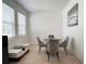 Well-lit dining area with a glass table, four chairs, and neutral decor, offering a serene atmosphere at 6358 Fairmont Ln, Palmetto, FL 34221
