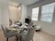 Bright dining space featuring a glass table, comfortable seating, and natural light through the windows at 6358 Fairmont Ln, Palmetto, FL 34221