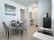 Elegant dining area with a glass table, plush chairs, and a calming artwork on the wall at 6358 Fairmont Ln, Palmetto, FL 34221