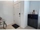 Inviting entryway with sleek tile flooring and a stylish storage unit for drinks and decor at 6358 Fairmont Ln, Palmetto, FL 34221