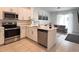 Modern kitchen with stainless steel appliances, white cabinets, and an open layout to the living area at 6358 Fairmont Ln, Palmetto, FL 34221