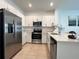 Well-equipped kitchen featuring stainless steel appliances, white cabinetry, and a functional, stylish design at 6358 Fairmont Ln, Palmetto, FL 34221