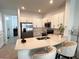 Open kitchen with white cabinets, stainless appliances, and barstool seating at 6358 Fairmont Ln, Palmetto, FL 34221