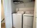 Bright laundry area with modern washer and dryer, featuring convenient overhead shelving for storage at 6358 Fairmont Ln, Palmetto, FL 34221