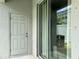Cozy patio with sliding glass door and secure storage door in backyard at 6358 Fairmont Ln, Palmetto, FL 34221