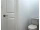 Powder room featuring a toilet, door and neutral paint, creating a minimalist and functional space at 6358 Fairmont Ln, Palmetto, FL 34221