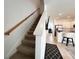 Carpeted staircase leading to the second floor with neutral walls and wooden handrail at 6358 Fairmont Ln, Palmetto, FL 34221
